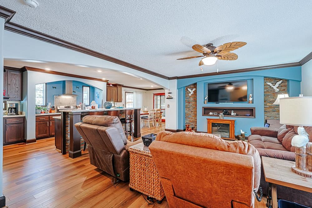 6773 Hampton Road Conway, SC 29527 - Photo 2 of 39 Living room featuring arched walkways, LVP floors, crown molding, a textured ceiling, and built in features