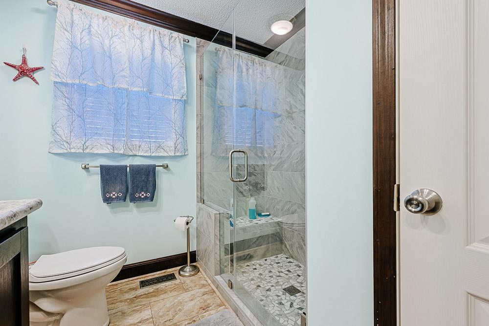 6773 Hampton Road Conway, SC 29527 - Photo 21 of 39 Bathroom with a shower stall, vanity, and a textured ceiling