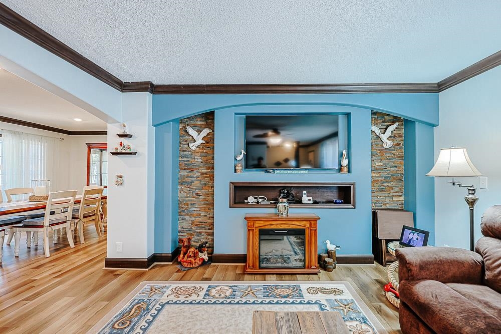 6773 Hampton Road Conway, SC 29527 - Photo 3 of 39 Living room with ornamental molding, LVP floors, arched walkways, a textured ceiling
