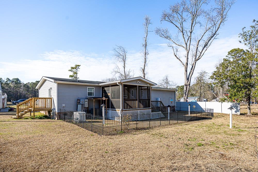 6773 Hampton Road Conway, SC 29527 - Photo 33 of 39 Rear view of house with a side wooden deck, a screened in porch, and a privacy fence