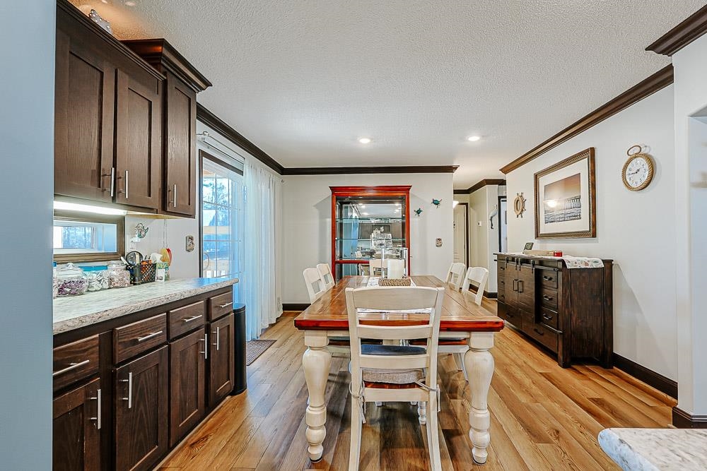 6773 Hampton Road Conway, SC 29527 - Photo 9 of 39 Dining room featuring crown molding, a textured ceiling, and LVP flooring