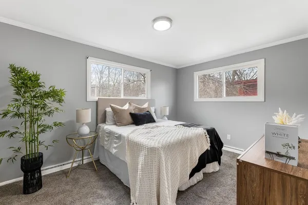a bedroom with a bed and a potted plant