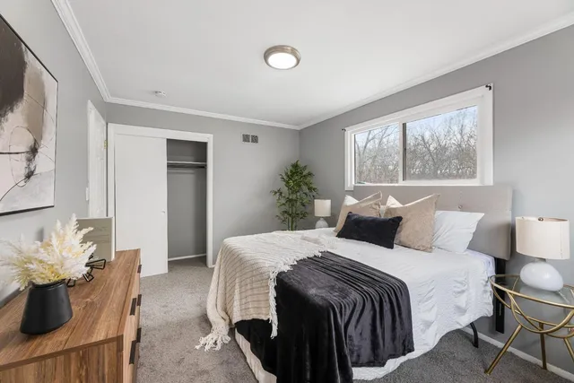 a bedroom with a bed and window