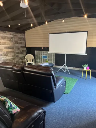a living room with chairs and a table