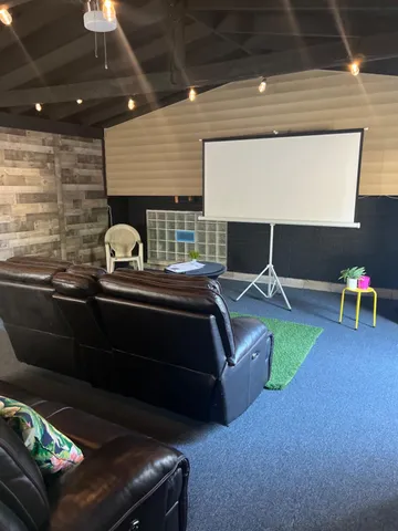 a living room with chairs and a table