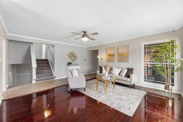 a living room with furniture and wooden floor