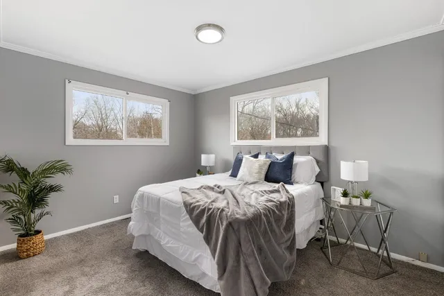 a bedroom with bed and a potted plant