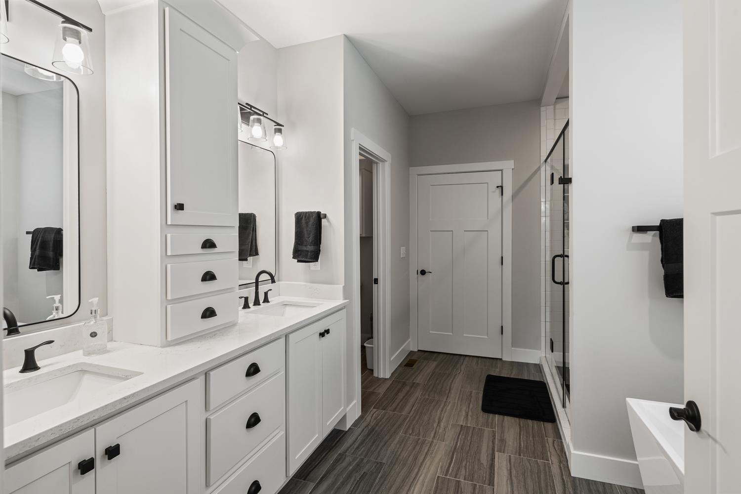 795 Madison Ridge Road Lawrenceburg, IN 47025 - Photo 31 of 72 Large extra height double sink vanity with linen storage cabinet in the center takes up most of the left.