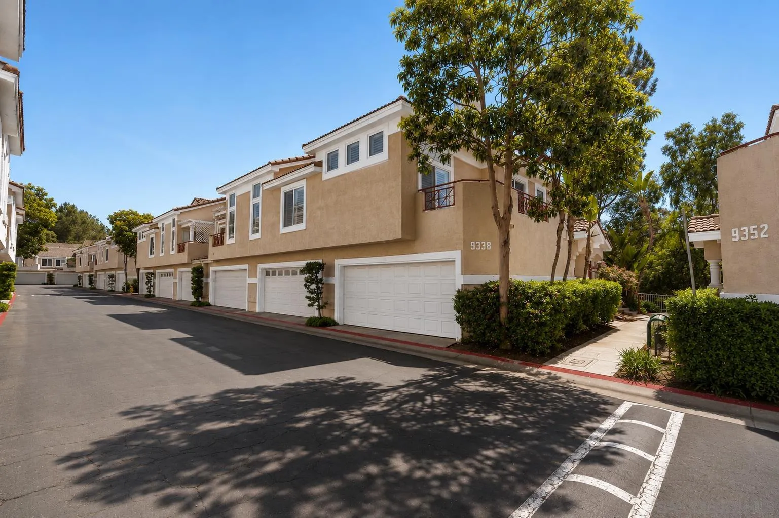 9338 Babauta Road, Unit 78 San Diego, CA 92129 - Photo 22 of 26 a front view of a house with a yard and garage