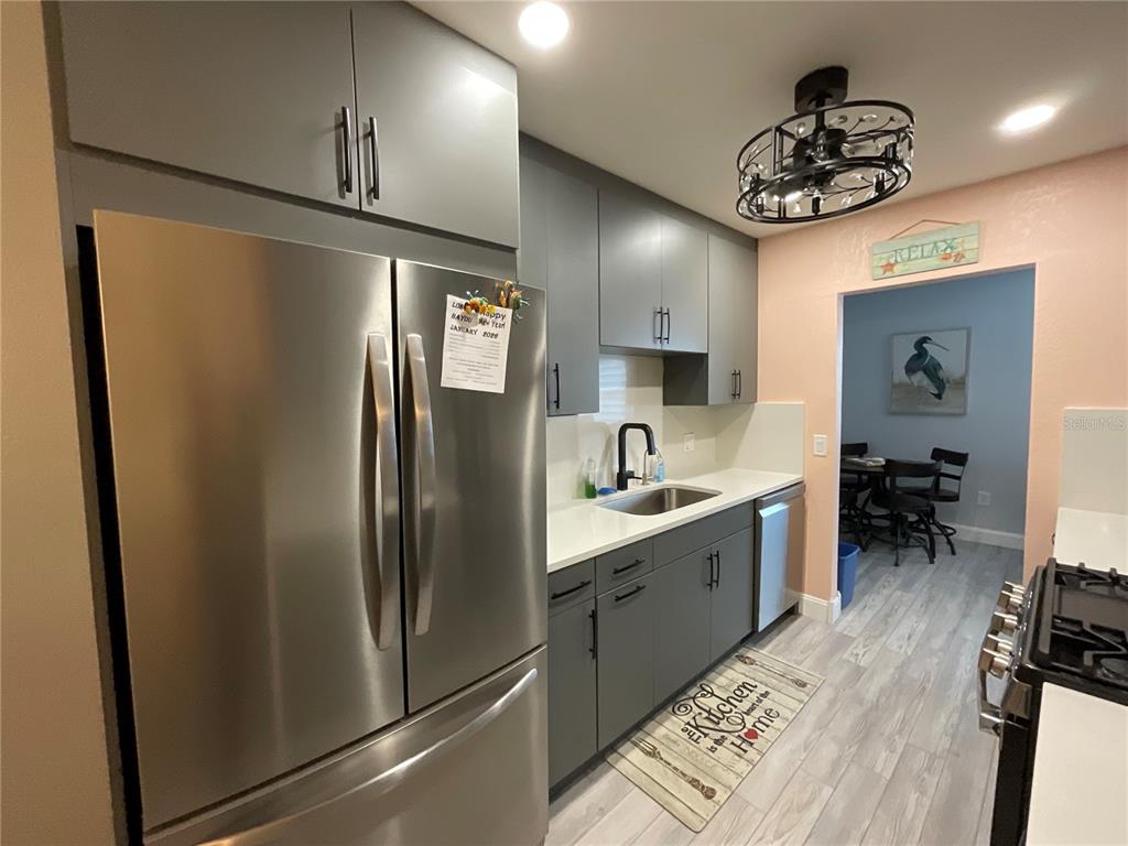 10036 63rd Avenue North, Unit 16 St. Petersburg, FL 33708 - Photo 11 of 30 a kitchen with stainless steel appliances a refrigerator and a sink