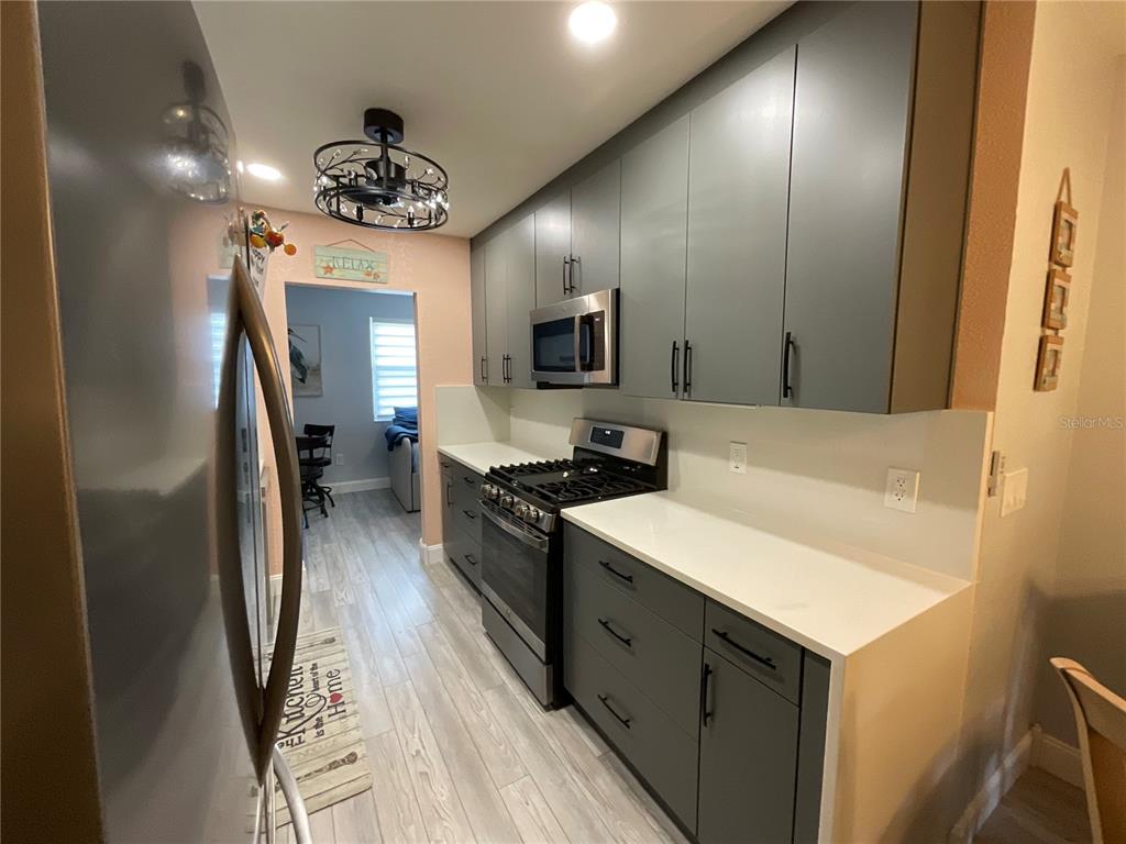 10036 63rd Avenue North, Unit 16 St. Petersburg, FL 33708 - Photo 12 of 30 a kitchen with a sink appliances and cabinets