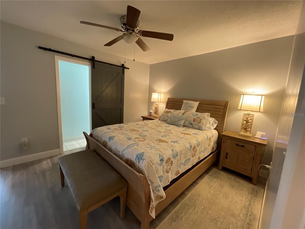 10036 63rd Avenue North, Unit 16 St. Petersburg, FL 33708 - Photo 17 of 30 a bed room with a bed and a ceiling fan