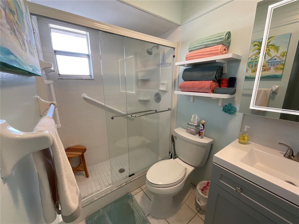 10036 63rd Avenue North, Unit 16 St. Petersburg, FL 33708 - Photo 20 of 30 a bathroom with a sink a toilet and shower