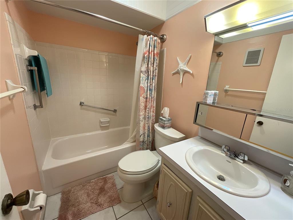 10036 63rd Avenue North, Unit 16 St. Petersburg, FL 33708 - Photo 22 of 30 a bathroom with a sink a toilet and shower