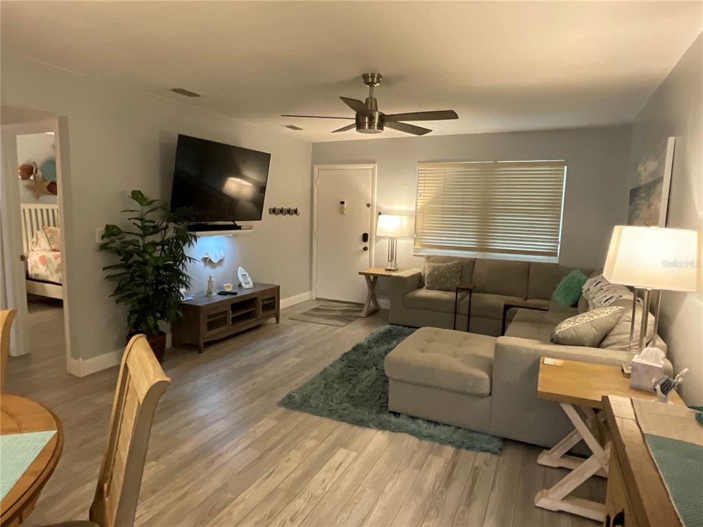 10036 63rd Avenue North, Unit 16 St. Petersburg, FL 33708 - Photo 7 of 30 a living room with furniture and a flat screen tv