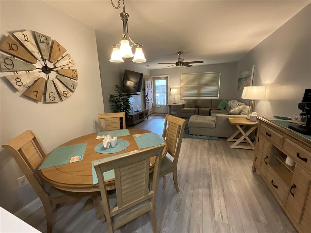 10036 63rd Avenue North, Unit 16 St. Petersburg, FL 33708 - Photo 8 of 30 a view of a dining room with furniture window and wooden floor