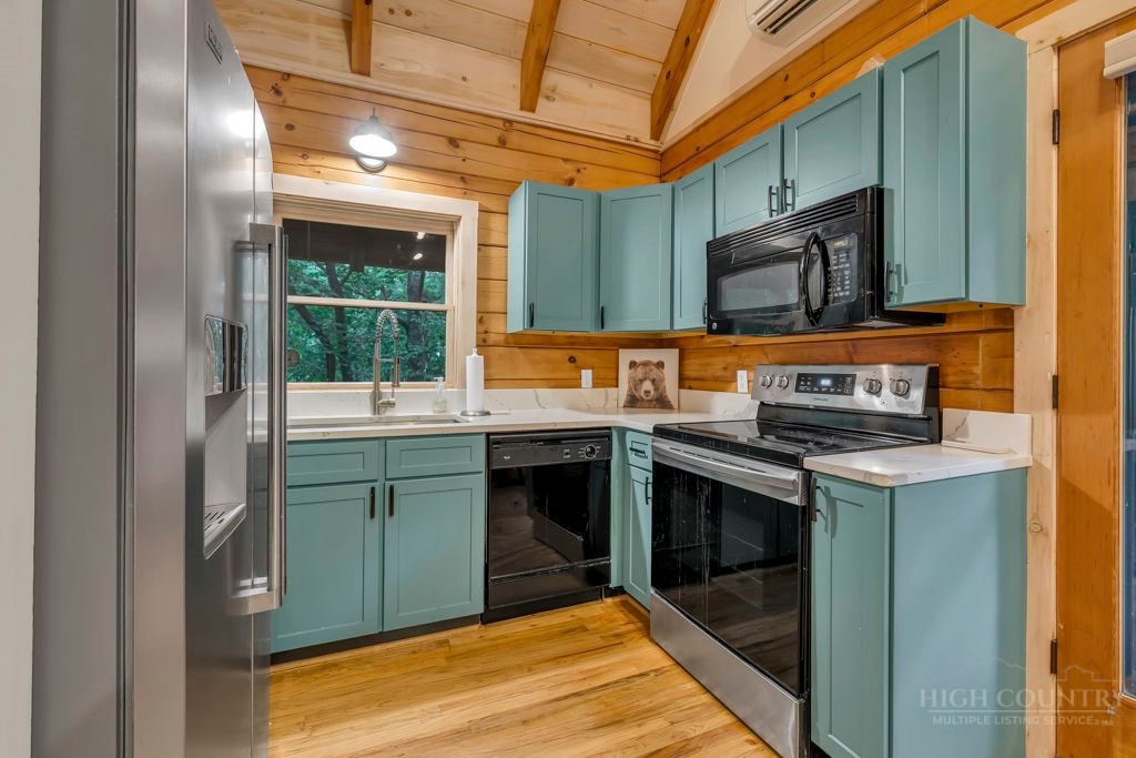 192 Dewitt Barnett Road Vilas, NC 28692 - Photo 12 of 32 a kitchen with a stove and a microwave