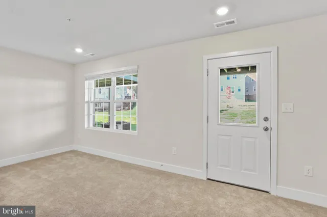 an empty room with windows and closet