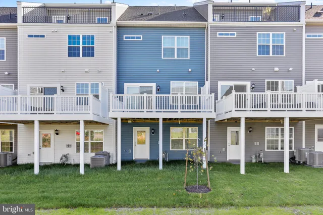 front view of a brick building with a yard