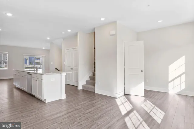 a view of a kitchen with furniture and wooden floor