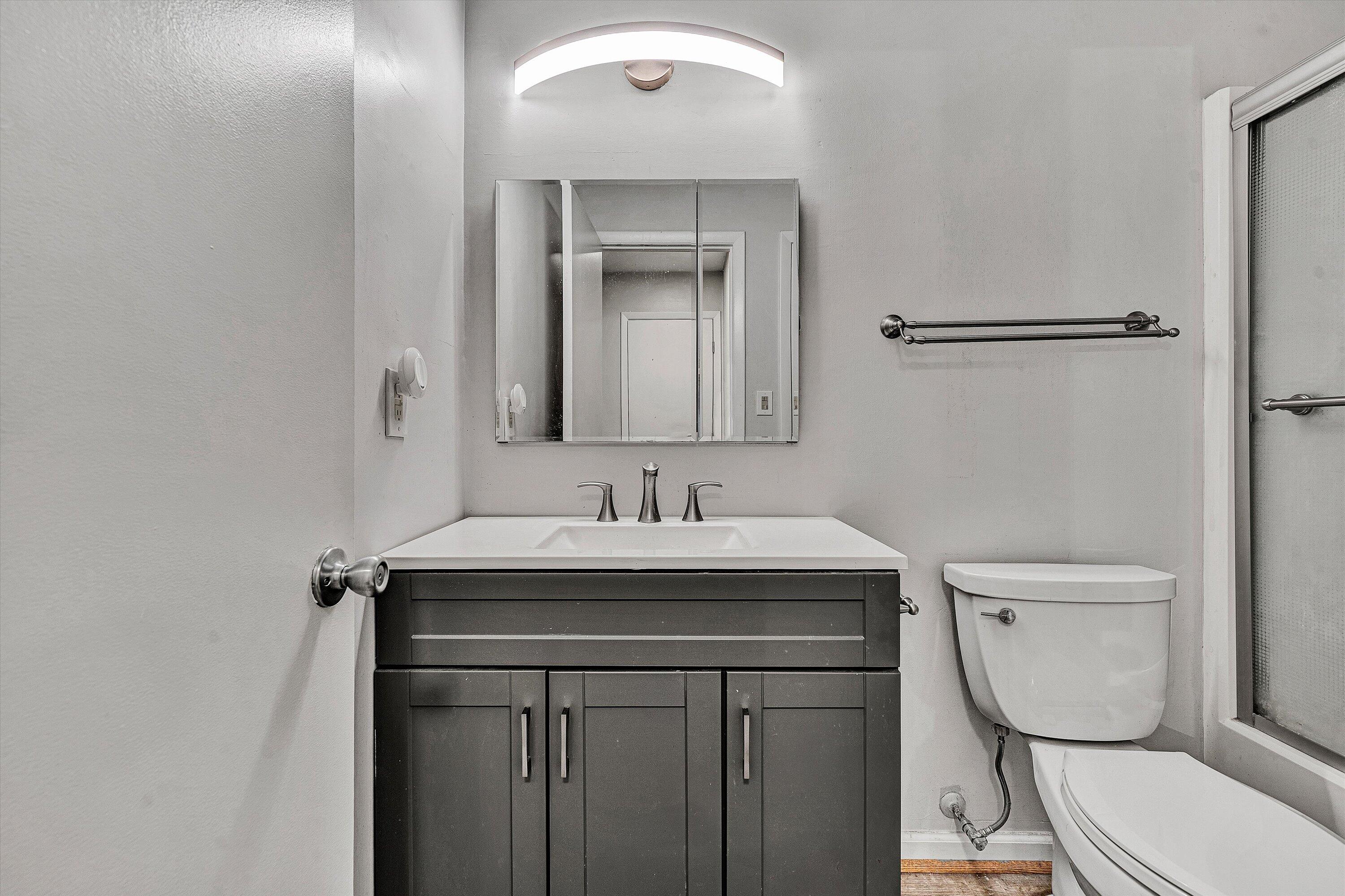 3549 Timberline Trail, Unit 149 Roanoke, VA 24018 - Photo 13 of 18 a bathroom with a granite countertop toilet sink and mirror