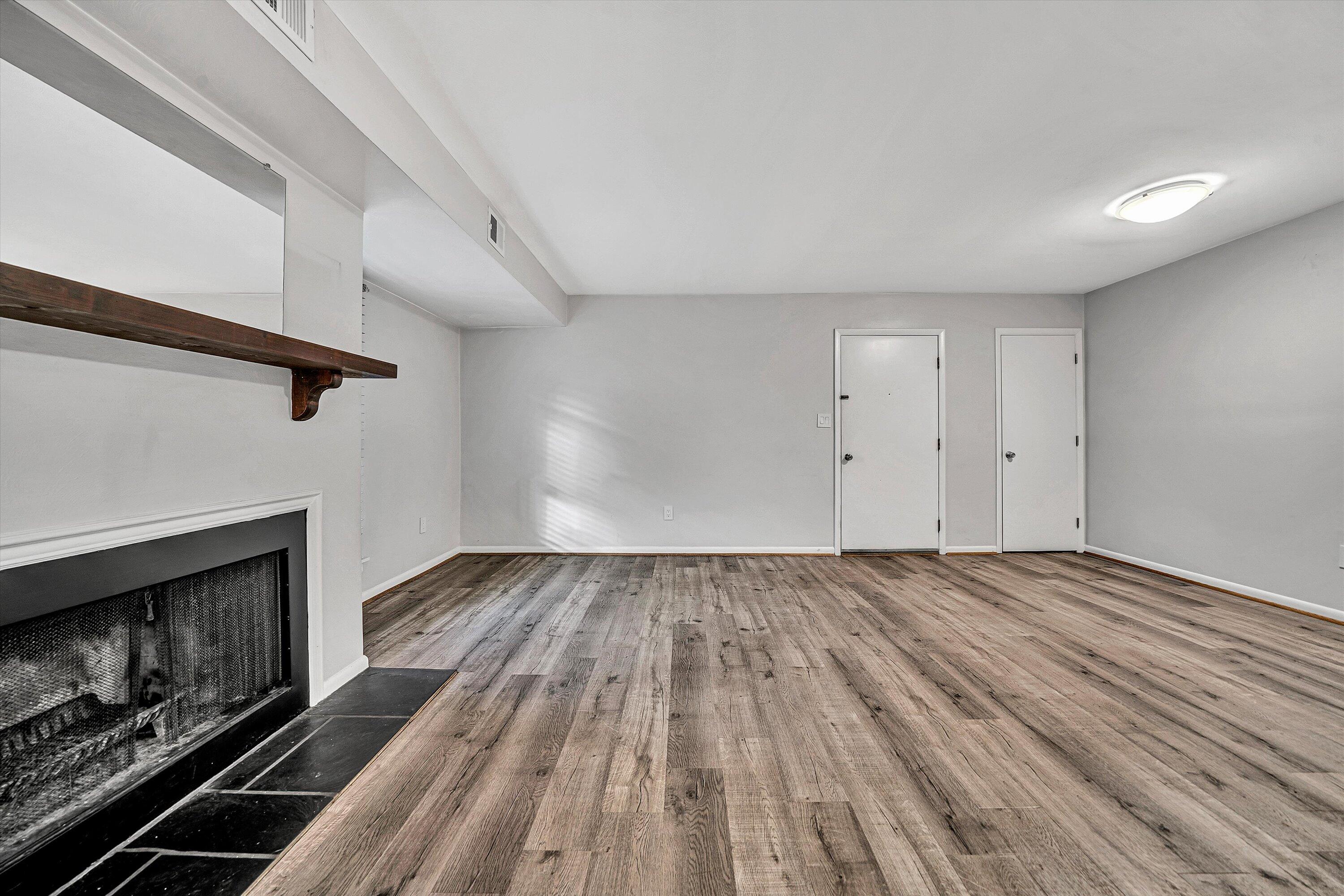 3549 Timberline Trail, Unit 149 Roanoke, VA 24018 - Photo 7 of 18 an empty room with wooden floor a fireplace and windows