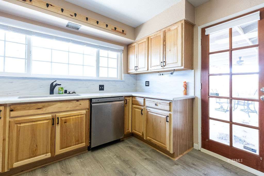 220 South American Street Ridgecrest, CA 93555 - Photo 11 of 25 a kitchen with stainless steel appliances cabinets a large window and a sink