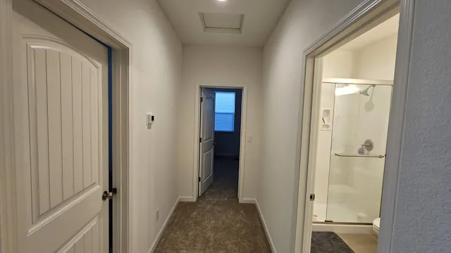 a view of a bathroom from a corridor