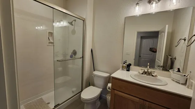 a bathroom with a sink toilet and shower