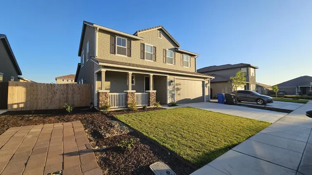 a front view of a house with yard