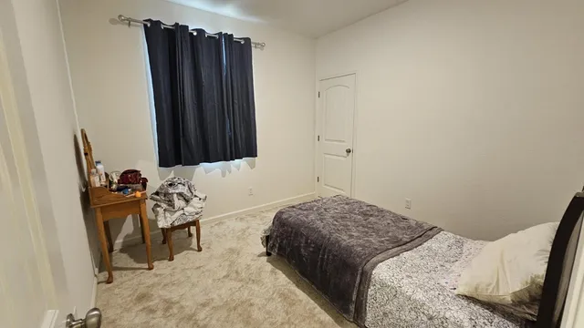 a bedroom with a bed and a window