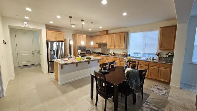 a kitchen with a sink refrigerator and cabinets
