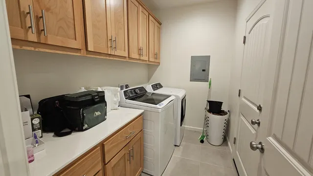 a view of a storage and utility room with washer and dryer