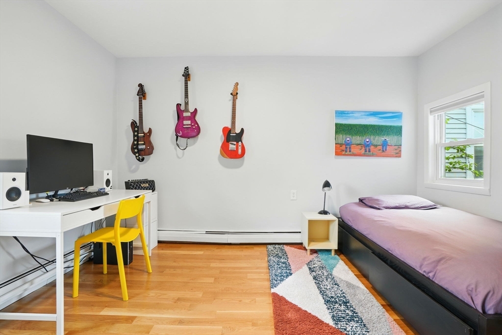 25 Bowdoin Street Somerville, MA 02143 - Photo 15 of 28 a bedroom with a bed and a flat screen tv