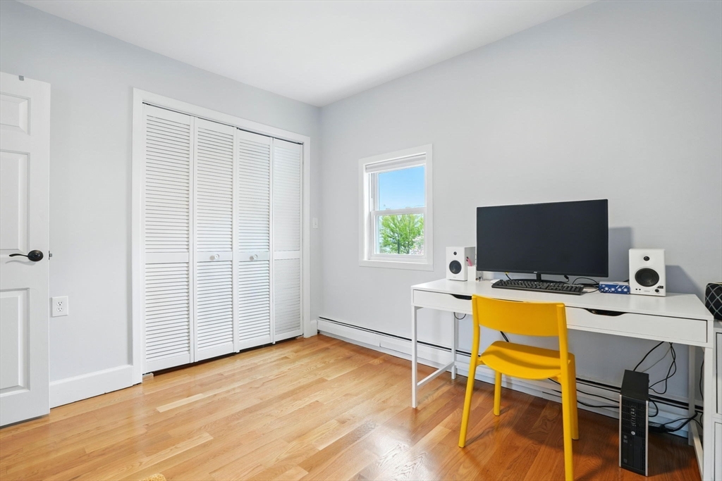 25 Bowdoin Street Somerville, MA 02143 - Photo 16 of 28 a view of a workspace with furniture and wooden floor