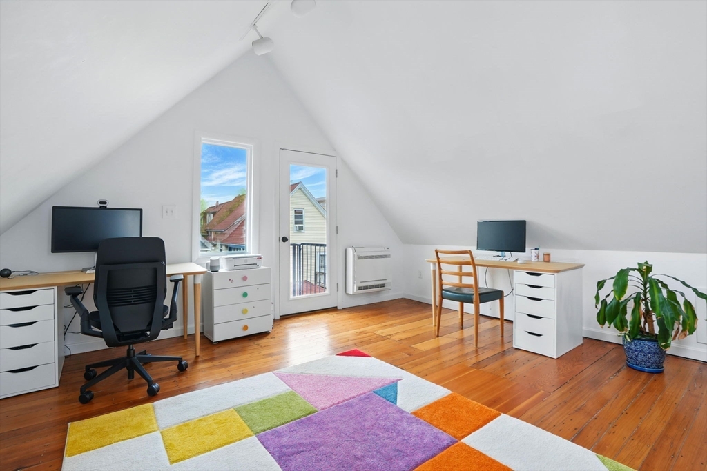25 Bowdoin Street Somerville, MA 02143 - Photo 18 of 28 a living room with furniture a wooden floor and a flat screen tv