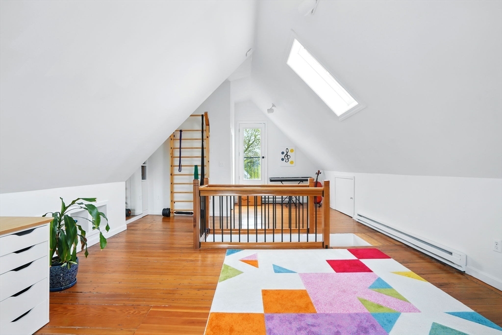 25 Bowdoin Street Somerville, MA 02143 - Photo 19 of 28 a bedroom with furniture and a wooden floor