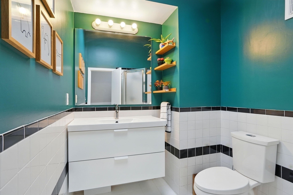 25 Bowdoin Street Somerville, MA 02143 - Photo 21 of 28 a bathroom with a sink toilet and mirror
