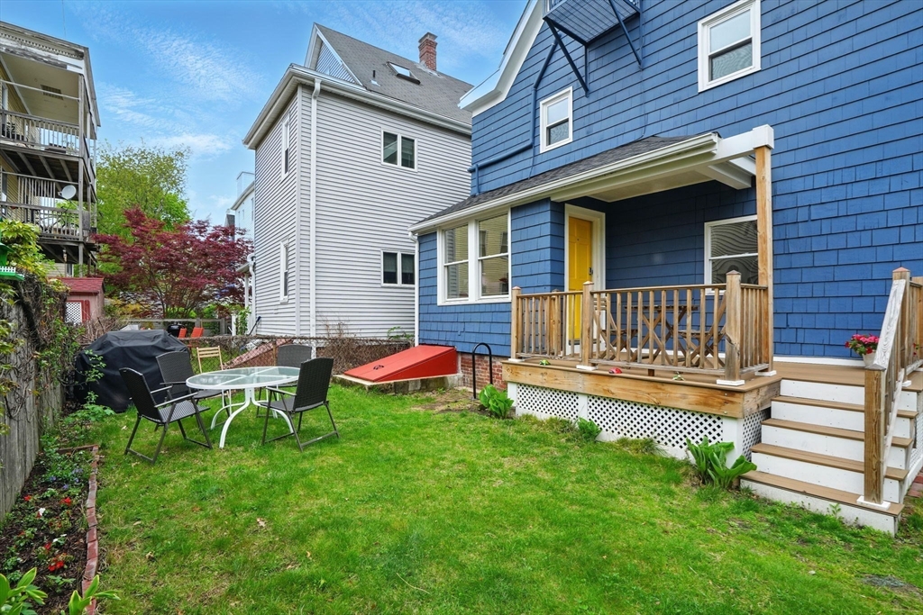 25 Bowdoin Street Somerville, MA 02143 - Photo 22 of 28 a view of a house with a yard chairs and a large tree