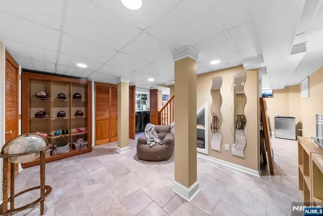 a living room with furniture a ceiling fan and a window