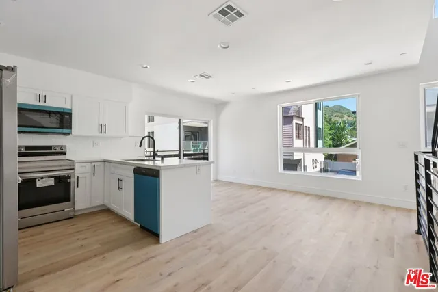 a kitchen with granite countertop a stove top oven and sink