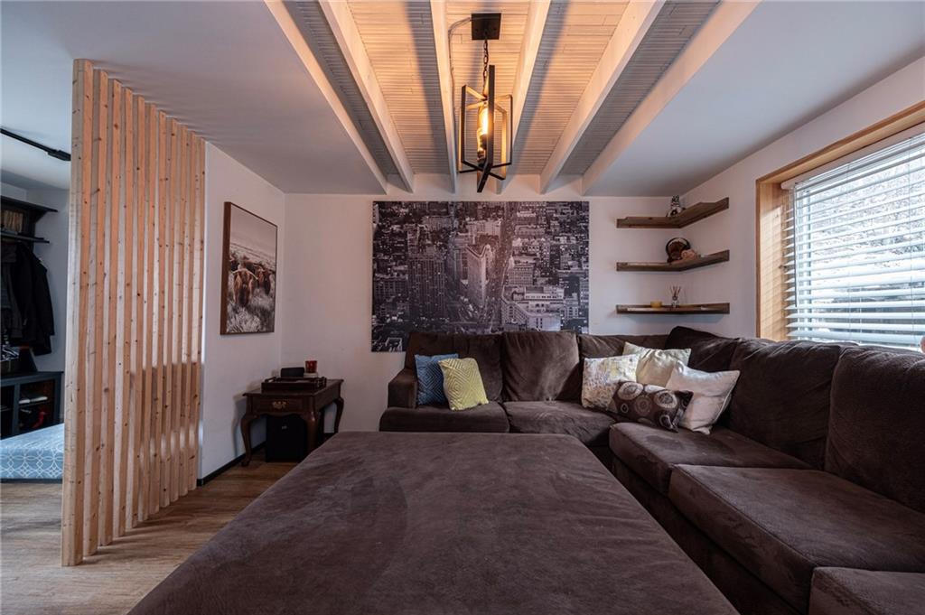 7608 Cheyenne Street Pittsburgh, PA 15218 - Photo 11 of 33 a living room with furniture a fireplace and a window