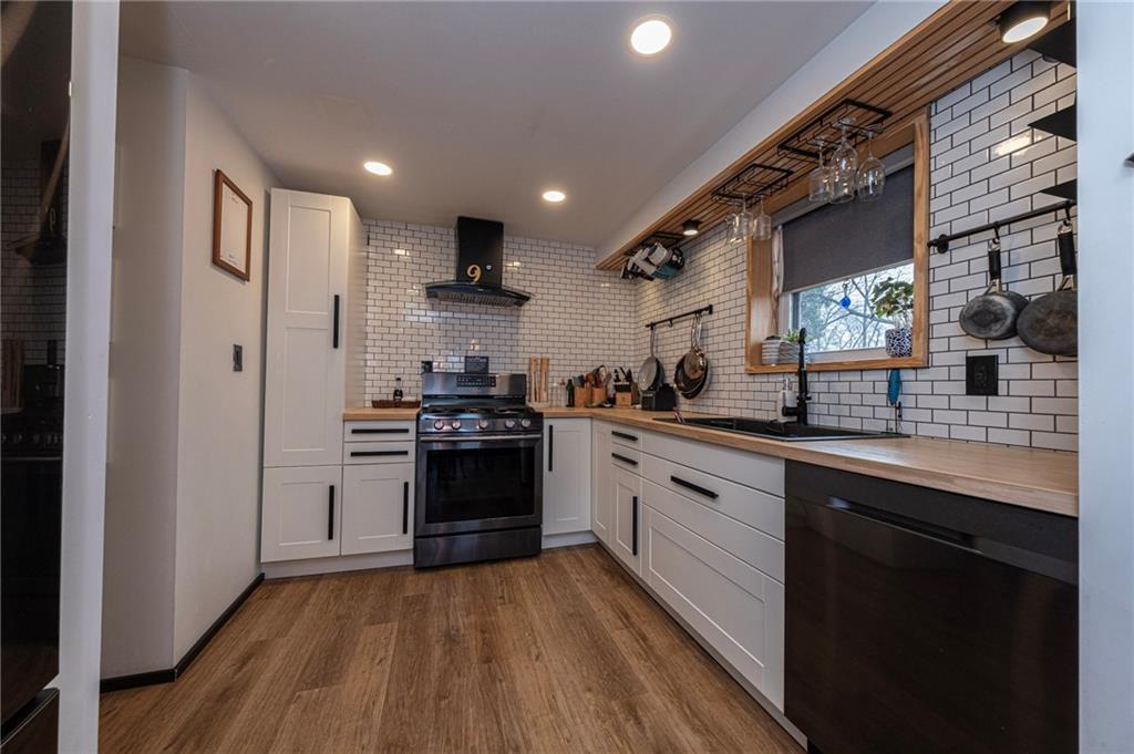 7608 Cheyenne Street Pittsburgh, PA 15218 - Photo 16 of 33 a kitchen with stainless steel appliances granite countertop a sink a stove and a refrigerator