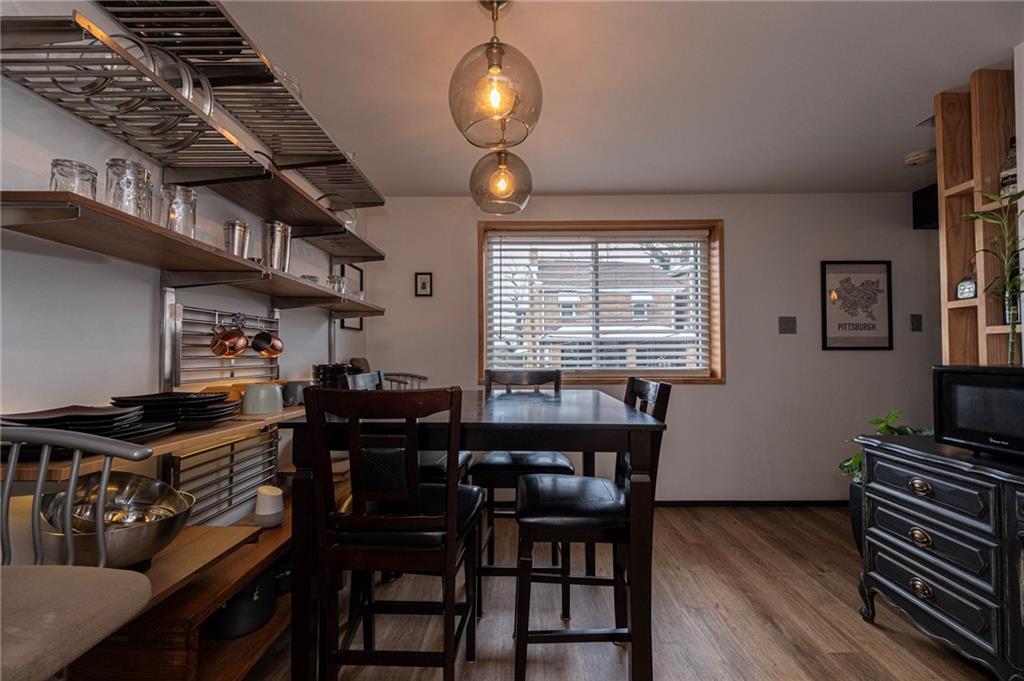 7608 Cheyenne Street Pittsburgh, PA 15218 - Photo 18 of 33 a view of a dining room with furniture window and wooden floor