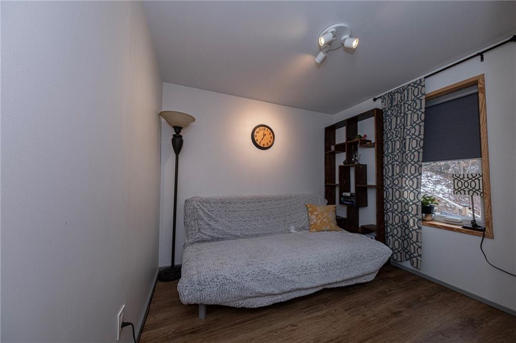 7608 Cheyenne Street Pittsburgh, PA 15218 - Photo 23 of 33 a bedroom with a bed and a chandelier