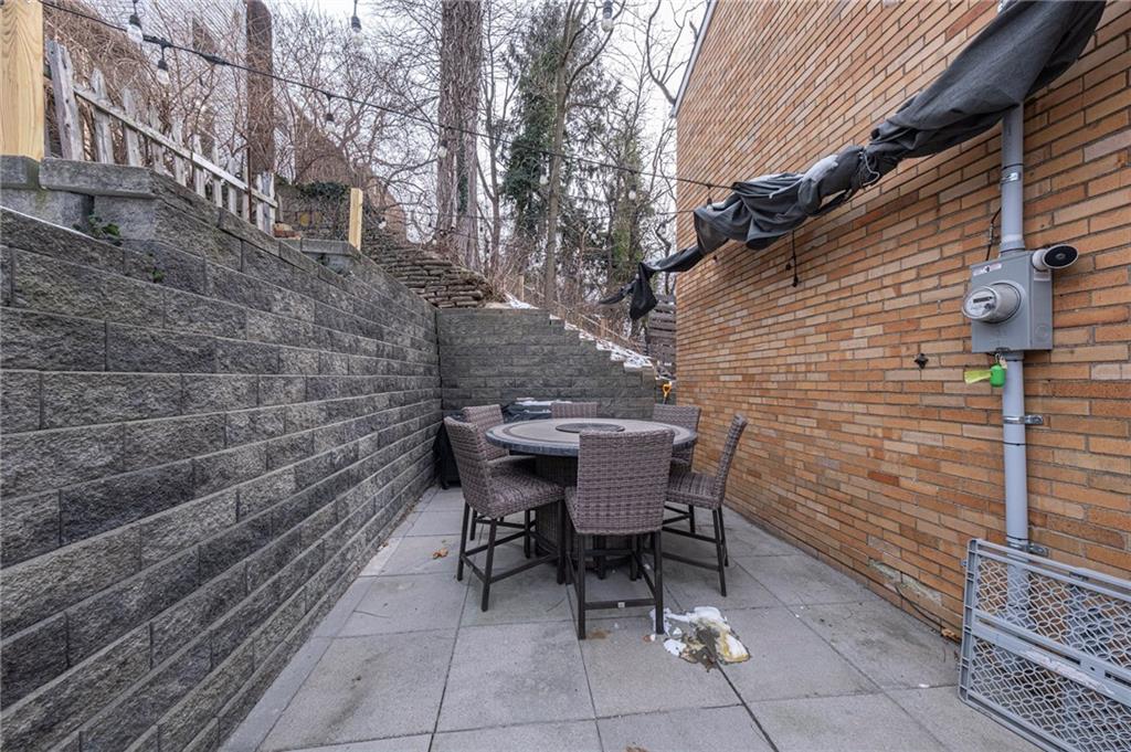 7608 Cheyenne Street Pittsburgh, PA 15218 - Photo 5 of 33 a backyard of a house with table and chairs