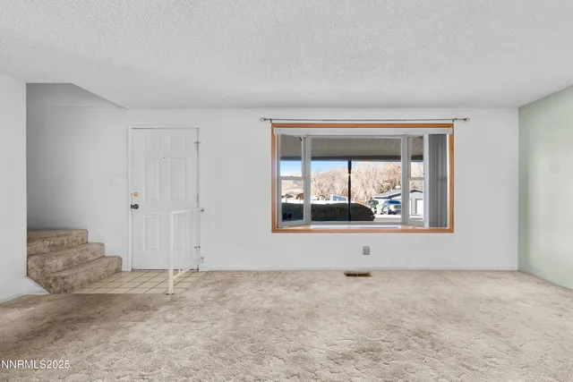 a kitchen with granite countertop a refrigerator stove top oven and sink