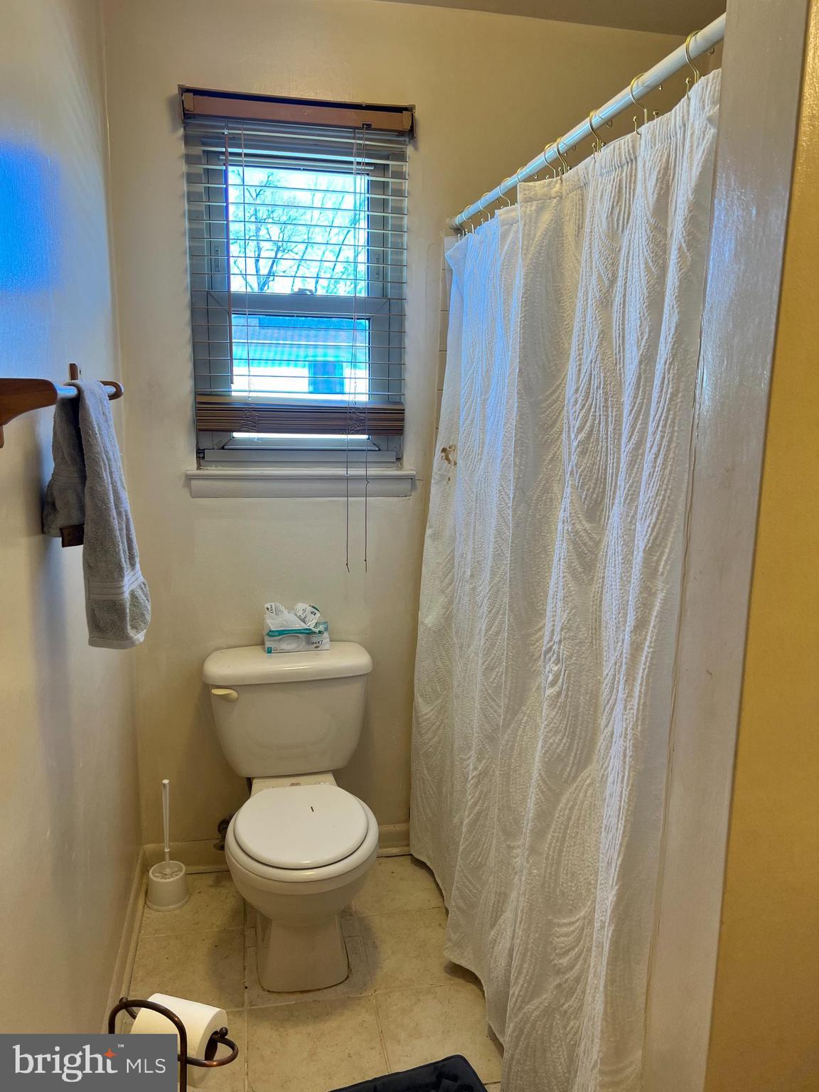 361 Independence Boulevard Lawnside, NJ 08045 - Photo 13 of 14 a bathroom with a toilet and a shower curtain