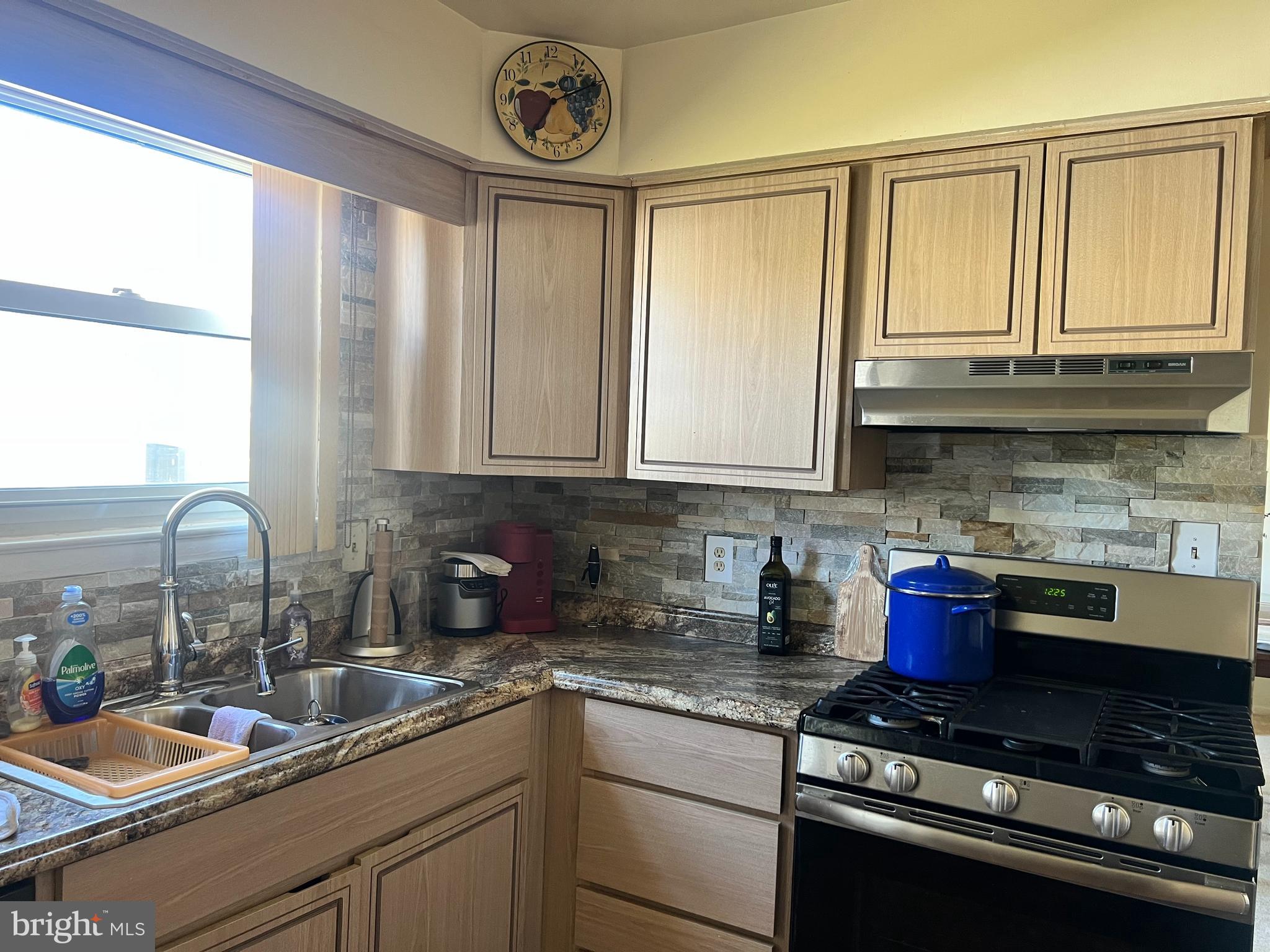 361 Independence Boulevard Lawnside, NJ 08045 - Photo 6 of 14 a kitchen with stainless steel appliances granite countertop a sink a stove and a wooden cabinets