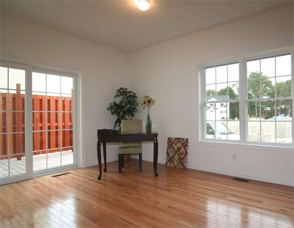6 Blue Jay Circle, Unit 2 Wakefield, MA 01880 - Photo 9 of 17 a view of an empty room with a window and wooden floor
